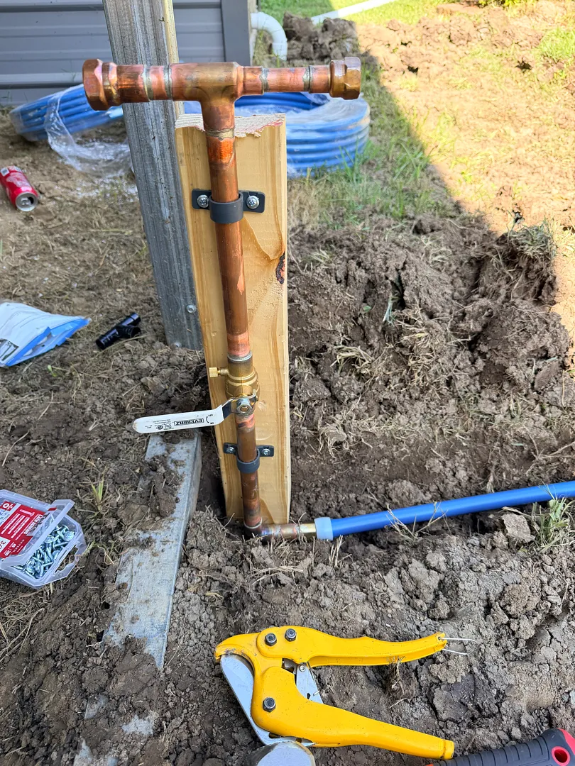 New copper water service riser with shutoff valve tied into blue PEX supply