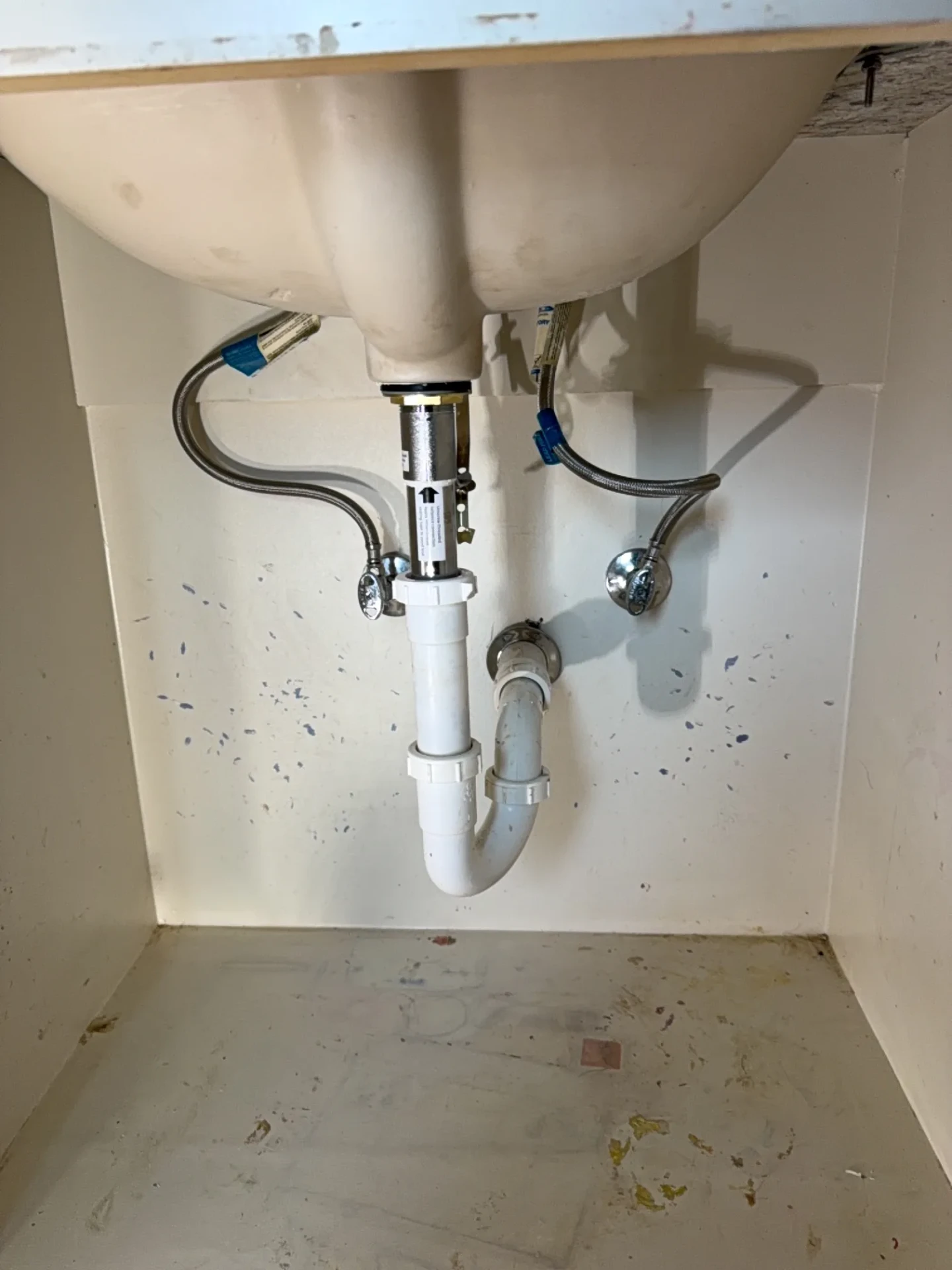 Clean new P-trap and supply lines under a bathroom sink
